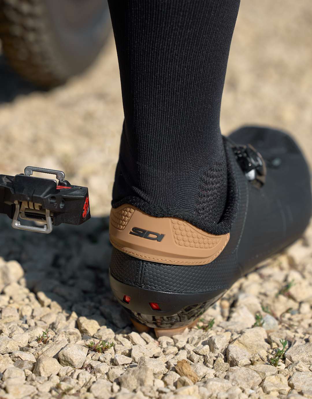 Cyclist foot standing in black and brown SIDI shoe