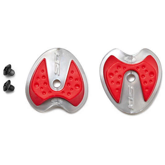 Two red and silver bike pedal covers with a small black screw on a white background