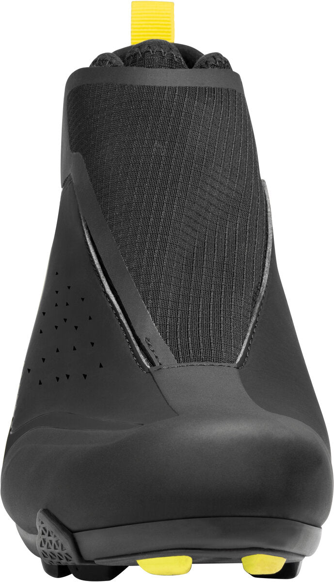 Black shoe with yellow accents on a white background