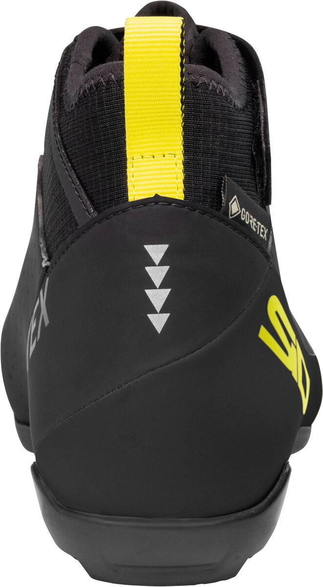 Black climbing shoe with yellow accents and brand logo on a white background