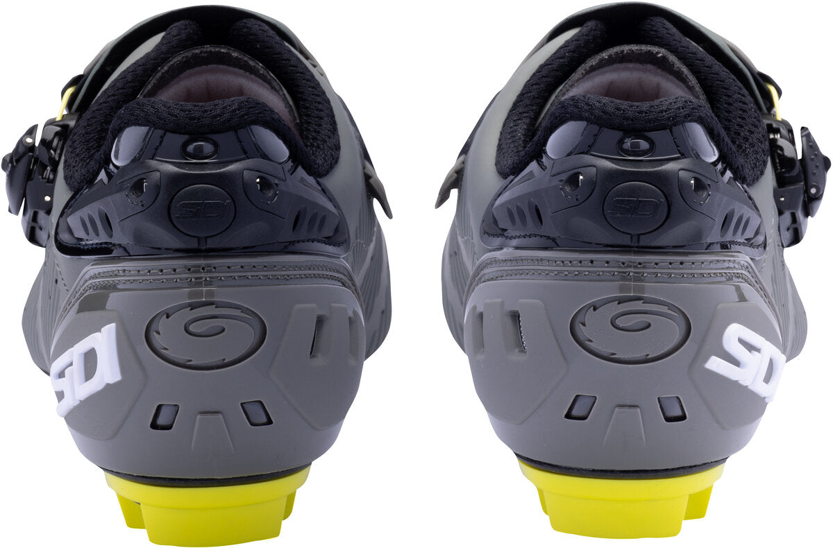 Gray cycling shoes with yellow sole on a white background