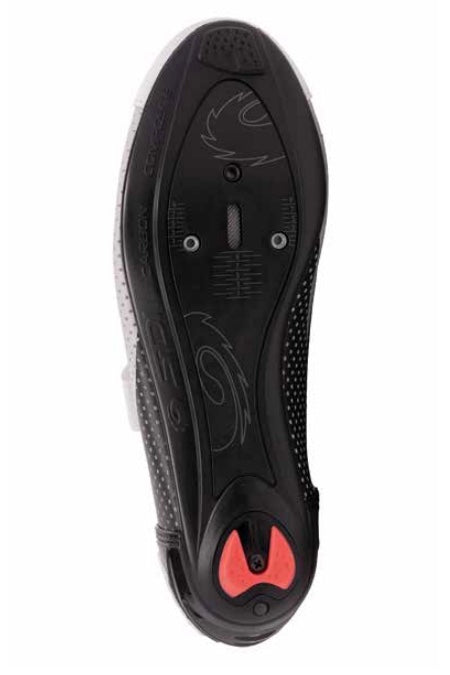 Close-up of a black shoe sole made with composed of nylon and injected carbon fiber with red accents on a white background