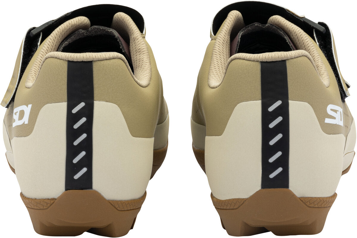 Pair of beige and brown cycling shoes with black accents on a white background