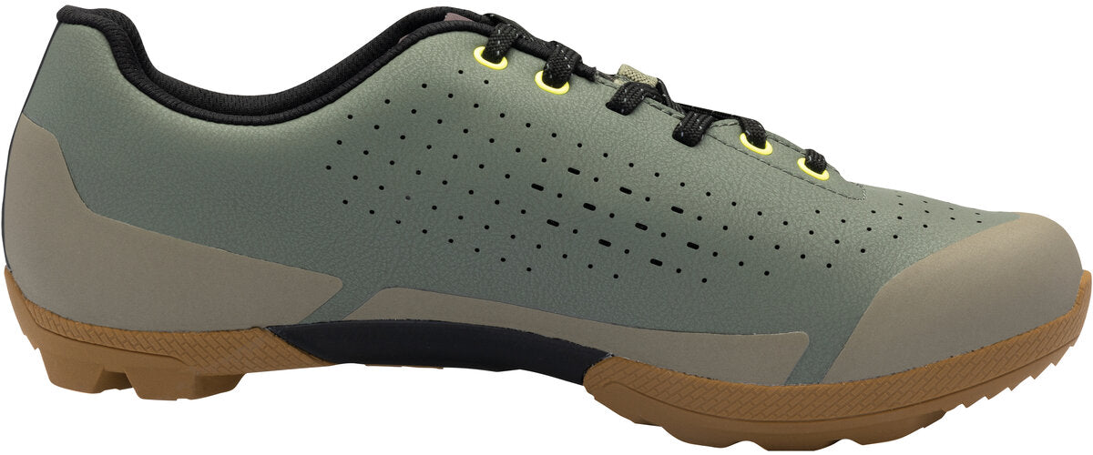 Green athletic shoe with brown sole on a white background