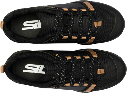 Black athletic shoes with brown accents and a visible brand logo on a white background
