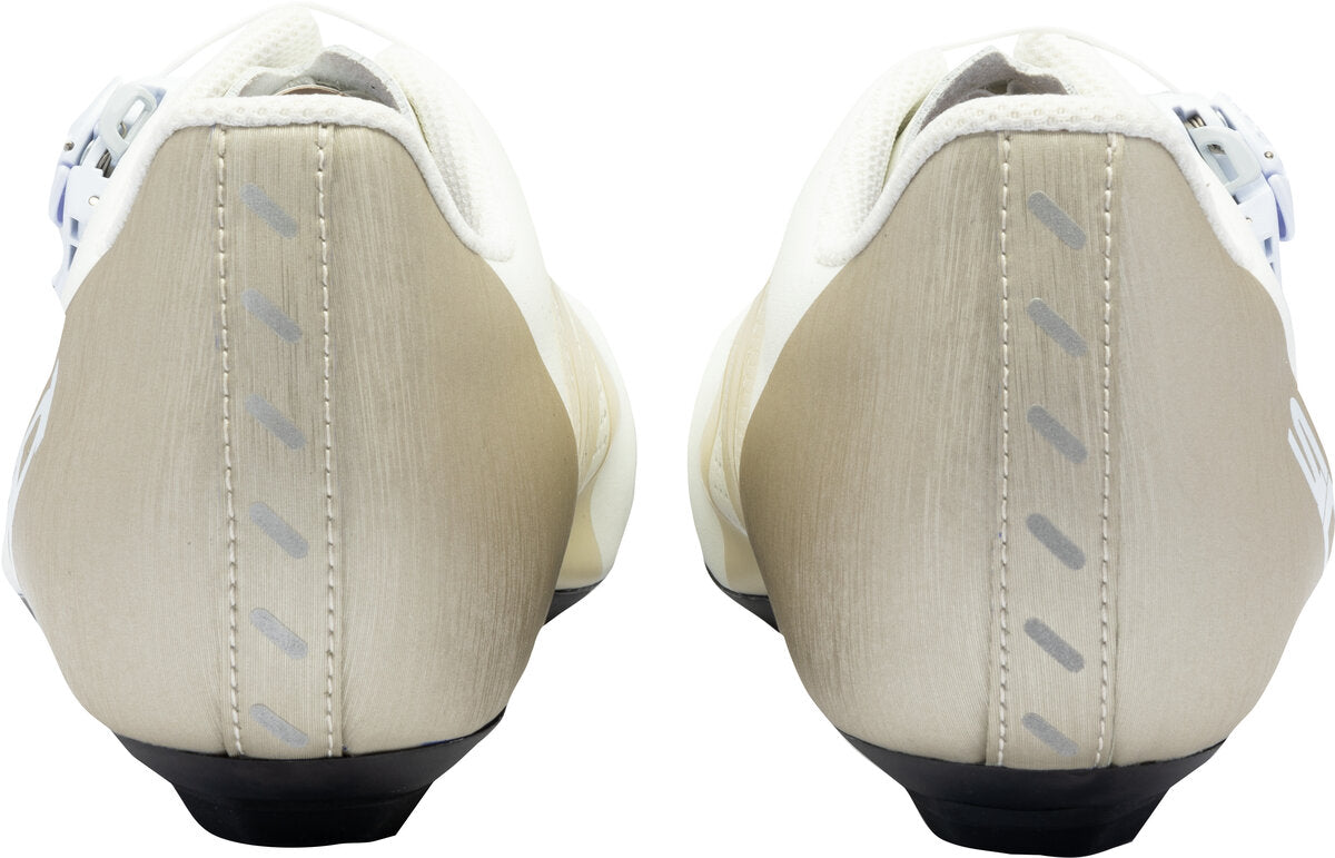 Close-up of beige shoes with black soles on a white background