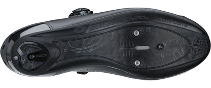Close-up of a black cycling shoe sole with brand logos on a white background