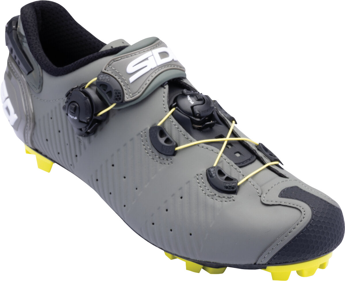Gray cycling shoe with yellow sole on a white background