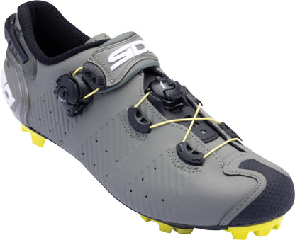 Gray cycling shoe with yellow sole on a white background