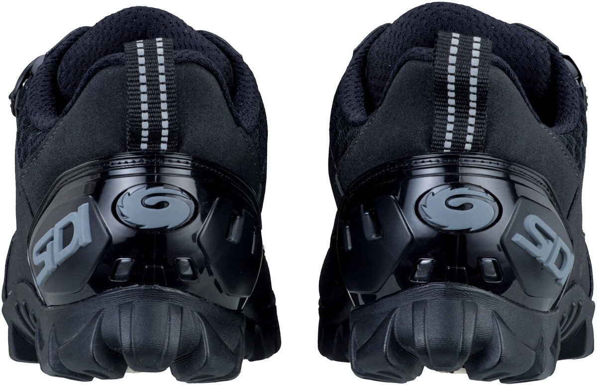Two black shoes with SIDI written on heel with grey accents. 
