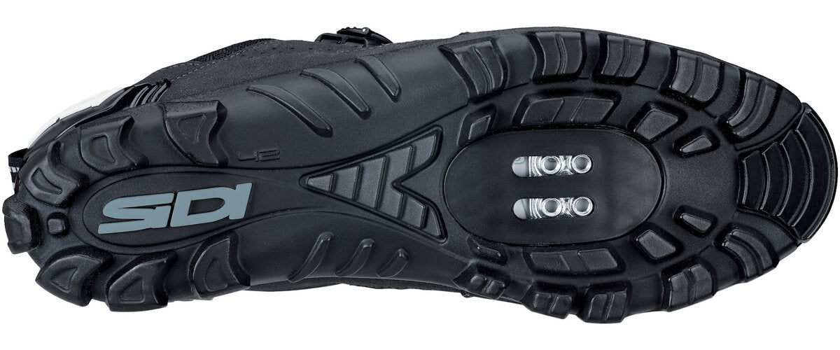 Close up of black sole with ridges and screw plate studs
