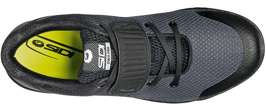 Black cycling shoe from top view with closed velcro strap and yellow inner sole