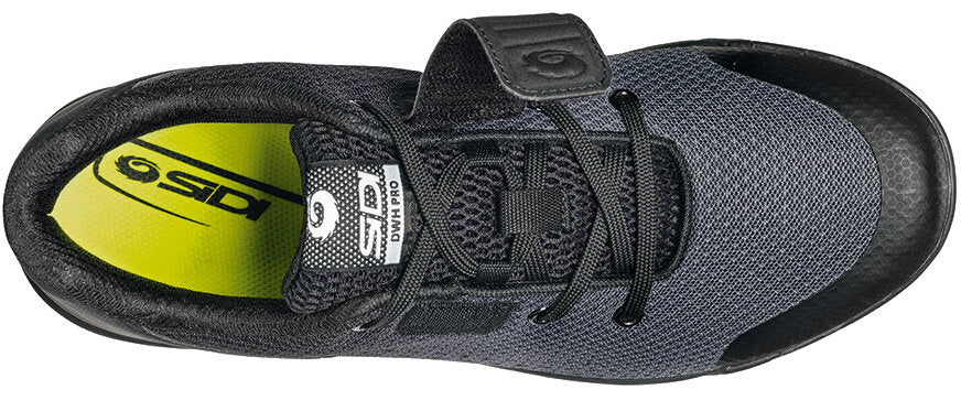 Black cycling shoe from top view with open velcro strap and yellow inner sole