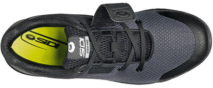 Black cycling shoe from top view with open velcro strap and yellow inner sole