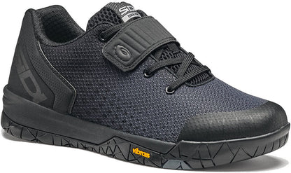 Black cycling shoe from side view with open velcro strap and SIDI logo on it