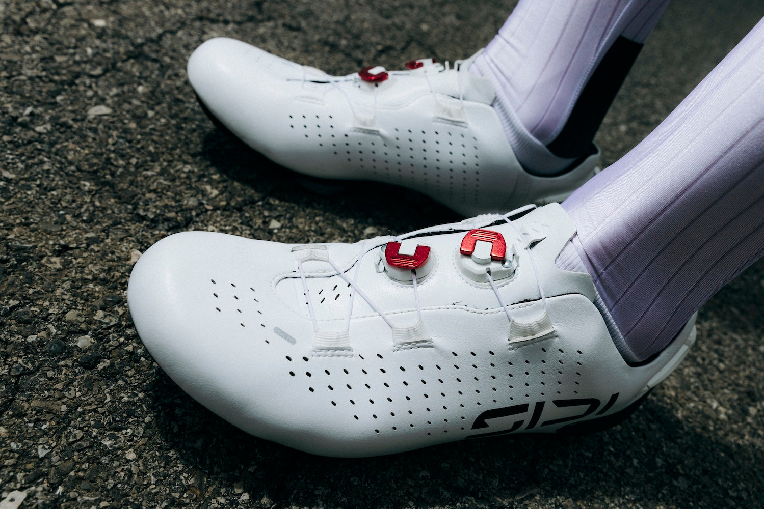 Closeup of a cyclist's feet wearing SIDI Shot 3 road cycling shoes in white