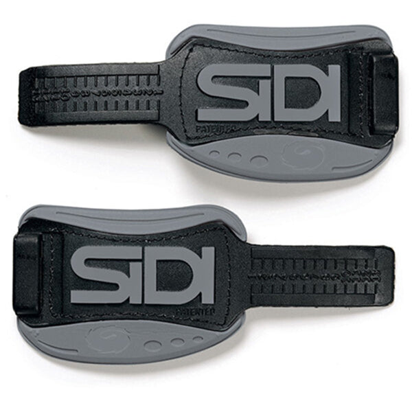 Two black and grey Sidi shoe straps on a white background