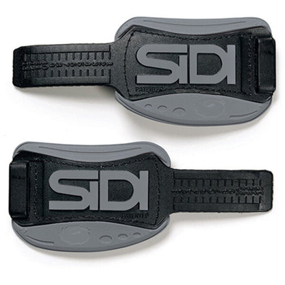 Two black and grey Sidi shoe straps on a white background