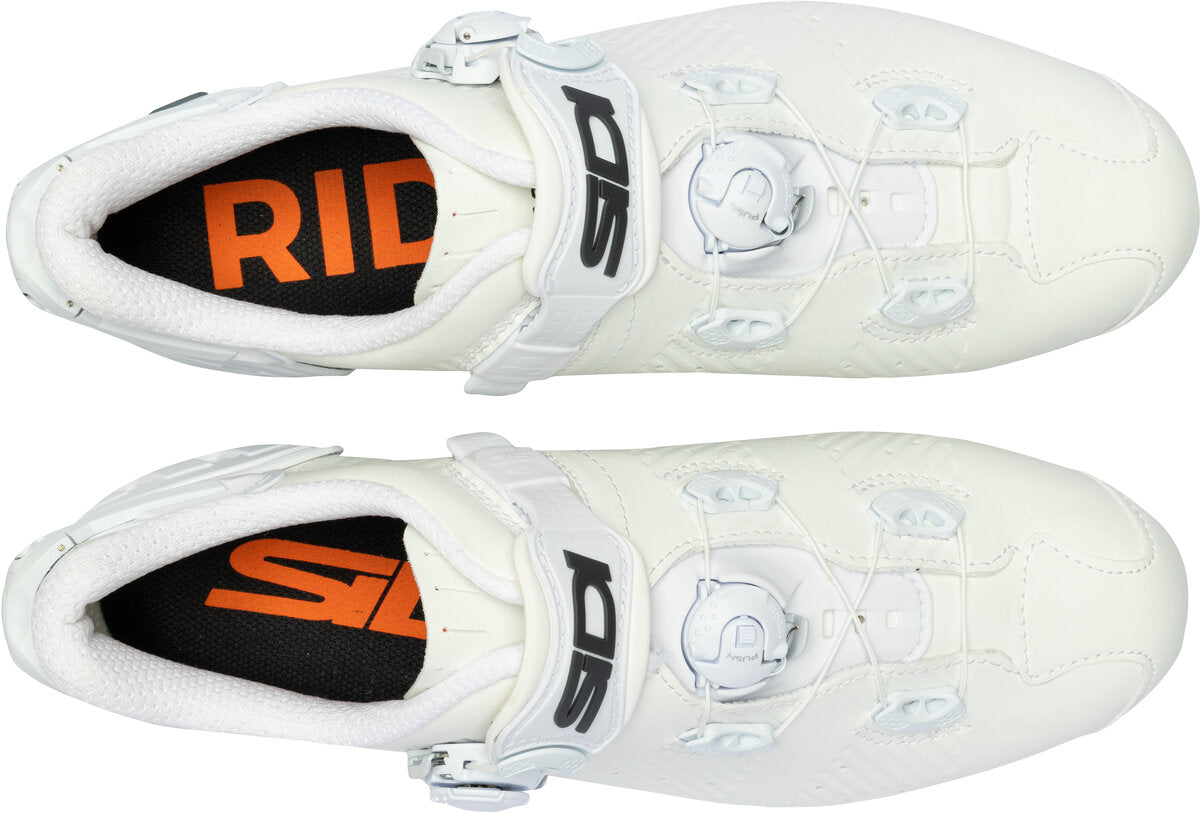 White cycling shoes with orange and black 'Ride' branding on a white background