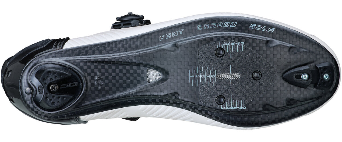 Close-up of a black and white shoe sole with brand name on a white background